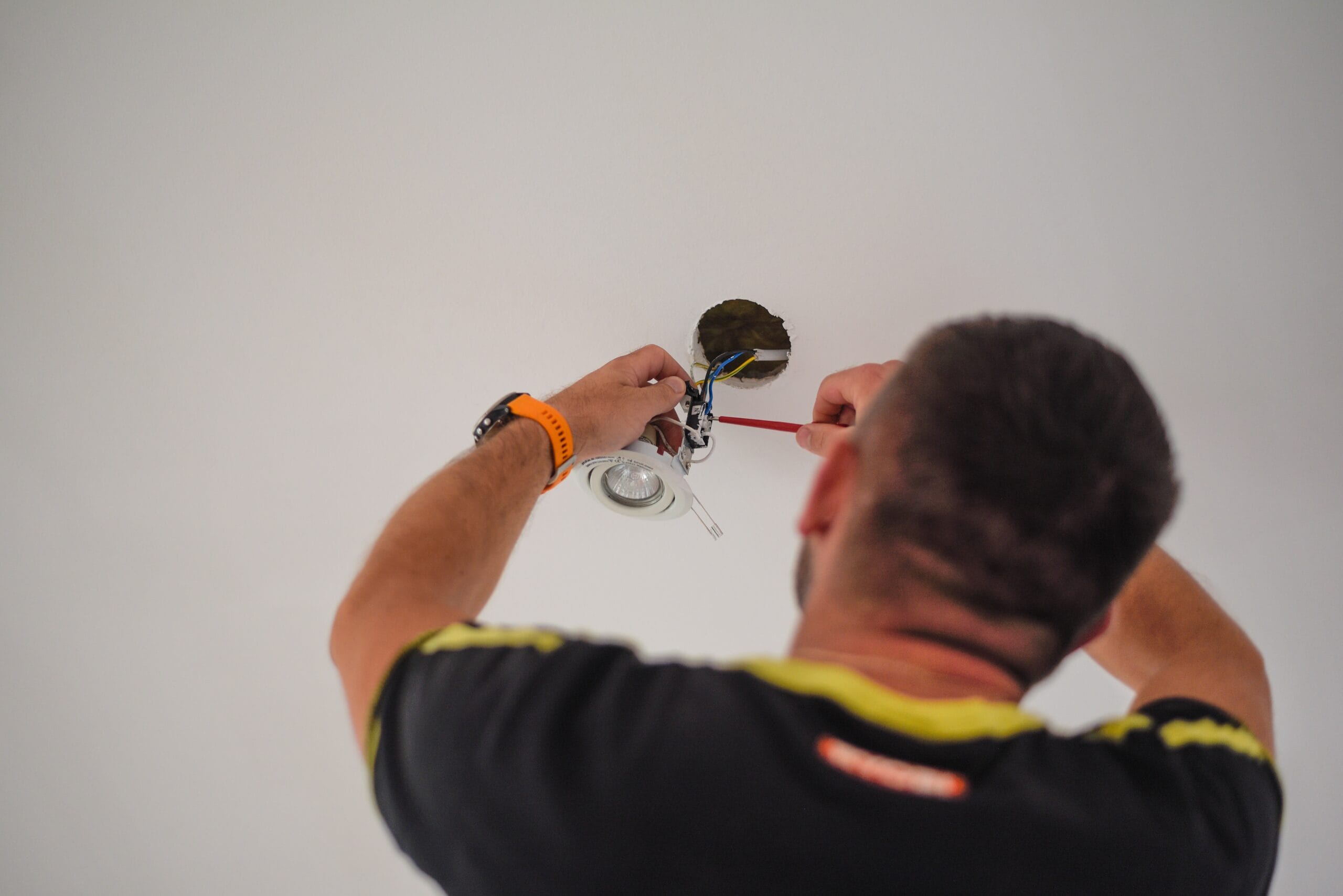 https://robinsonco.uk/wp-content/uploads/2025/04/back-view-of-a-handyman-fixing-electricity-wires-i-2024-11-27-12-20-32-utc.jpg